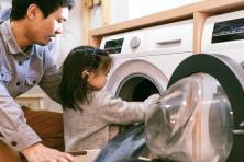 father and daughter doing laundry